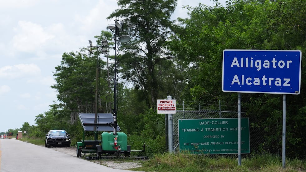 FILE -- A Florida Highway Patrol car guards the entrance to the "Alligator Alcatraz" detention...