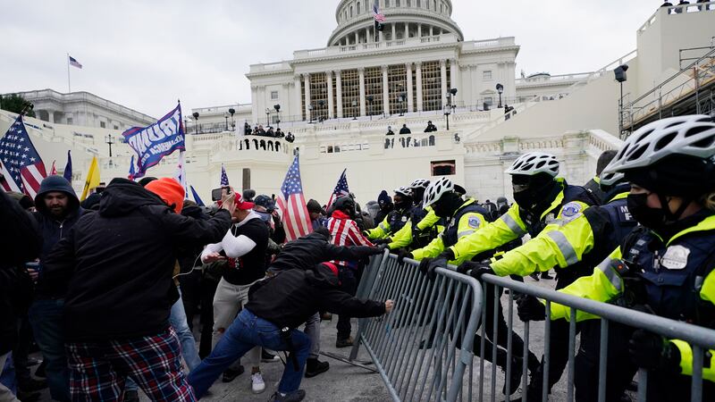 FILE - Trump supporters try to break through a police barrier at the Capitol in Washington on...