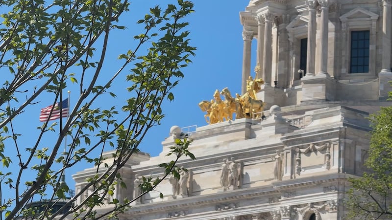 Minnesota's Capitol Dome shown through a few surrounding trees on a spring day.
