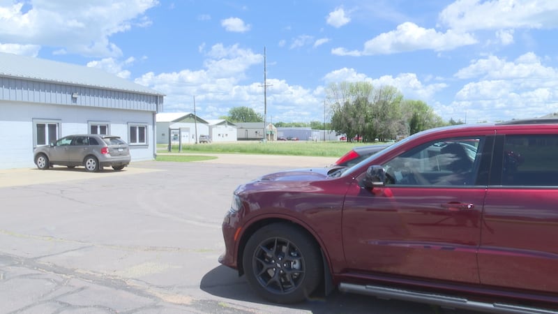 A car leaving the CREST parking lot. Fairmont, MN, June 12, 2026.